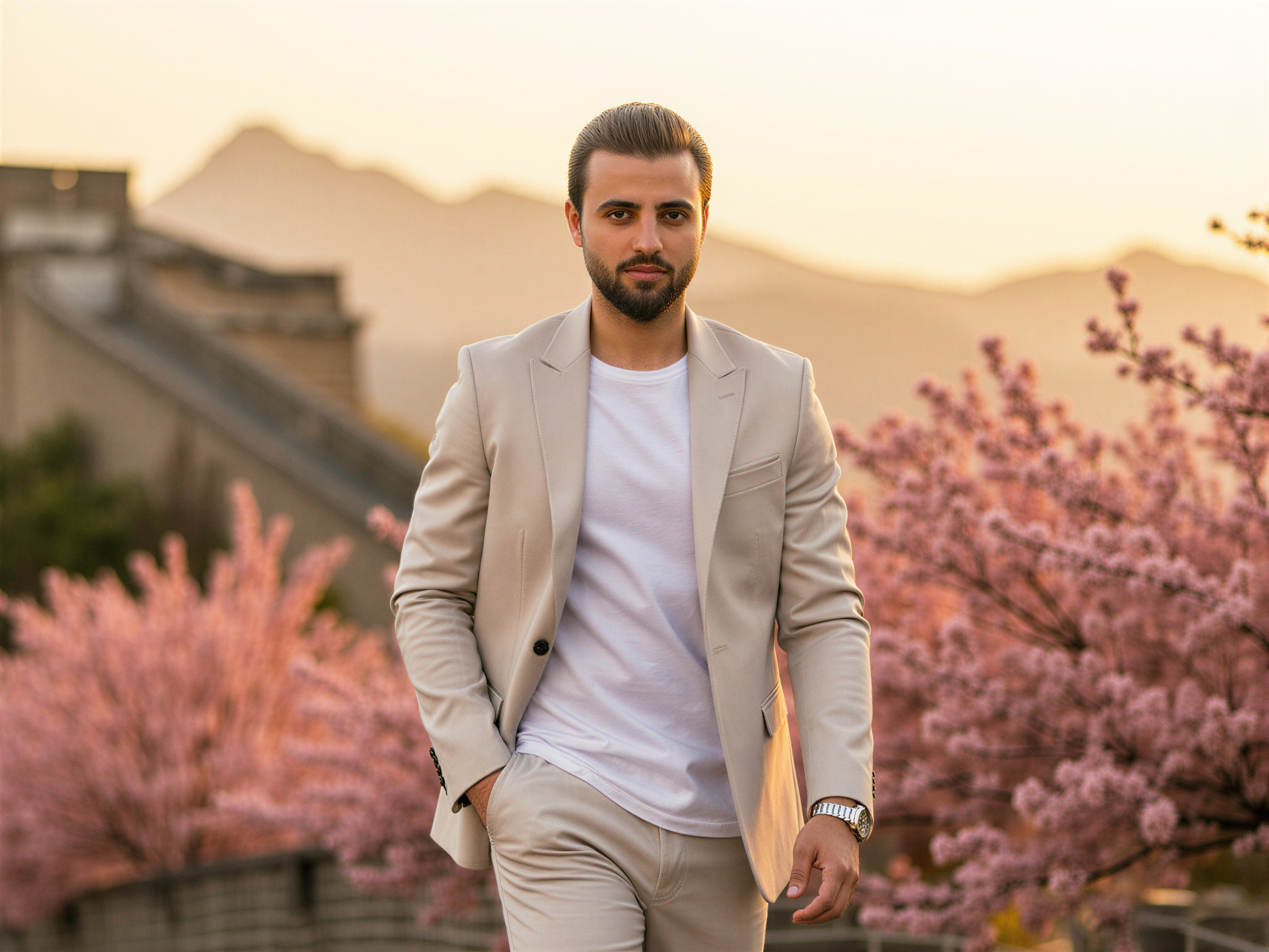A joyful male figure, OD62S, aged 32, stands against a picturesque backdrop of iconic Chinese landmarks, such as the Great Wall and vibrant cherry blossoms in full bloom. He wears a modern, tailored outfit—an ivory linen blazer over a crisp white shirt paired with relaxed-fit trousers—a perfect blend of contemporary fashion and cultural homage. His expression beams with happiness, capturing the essence of a carefree traveler immersed in the beauty of his surroundings. The warm, golden hour light bathes the scene, creating an inviting and cheerful atmosphere. This editorial-style photograph exudes a sense of joy, adventure, and appreciation for culture.
