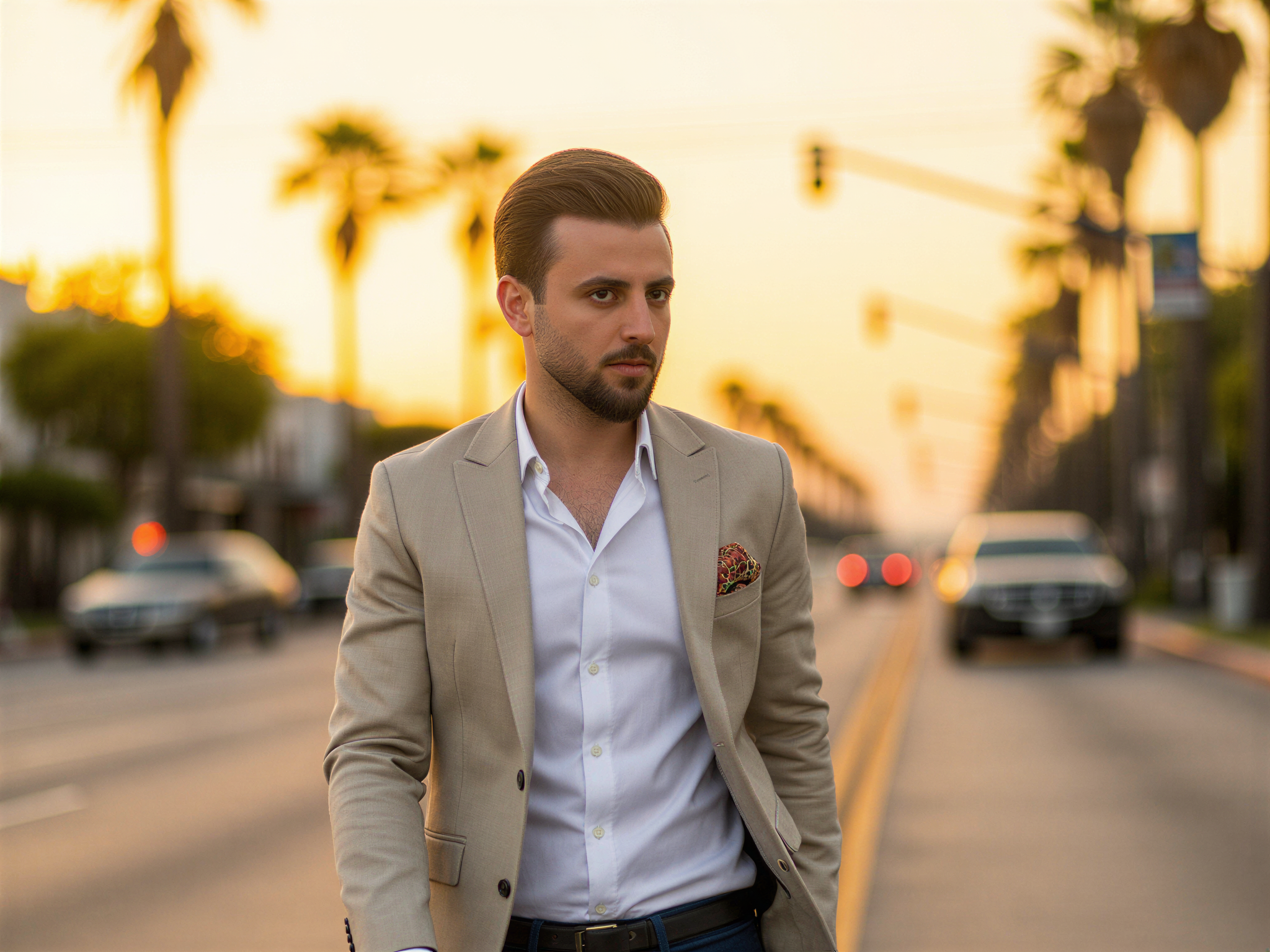 A dapper male individual, OD62S, aged 32, radiating happiness as he strolls along a vibrant Los Angeles street. He is dressed in a light linen blazer layered over a crisp white shirt and tailored denim, embodying a relaxed yet sophisticated Californian style. The sun casts a golden glow, creating a warm ambiance while palm trees sway gently in the background. His confident smile and easygoing demeanor capture the essence of the LA lifestyle, evoking a sense of joy and freedom in this lively outdoor scene.