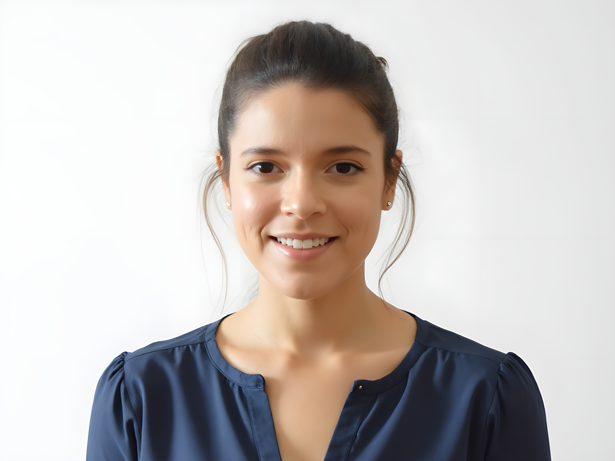 Smiling woman in a navy blue blouse with a neutral background.
